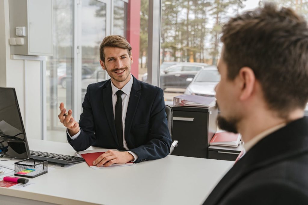 Two businessmen having a conversation in a modern office setting.